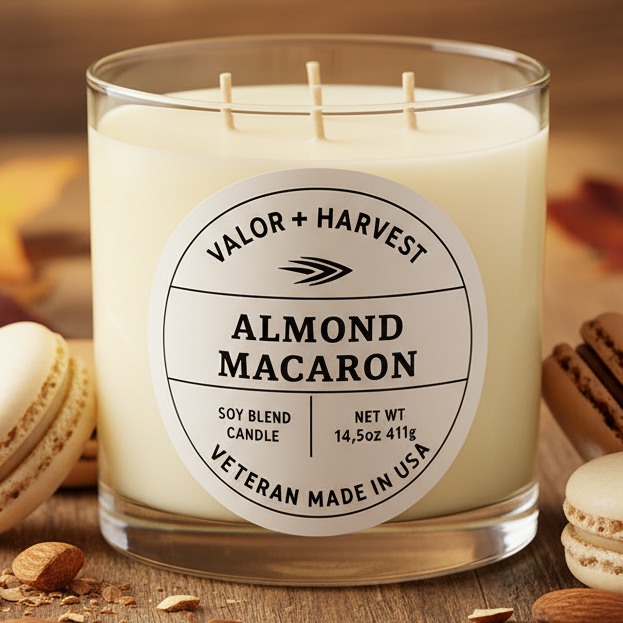 Candle labeled 'Almond Macaron' with macaron cookies and almonds on a wooden surface.