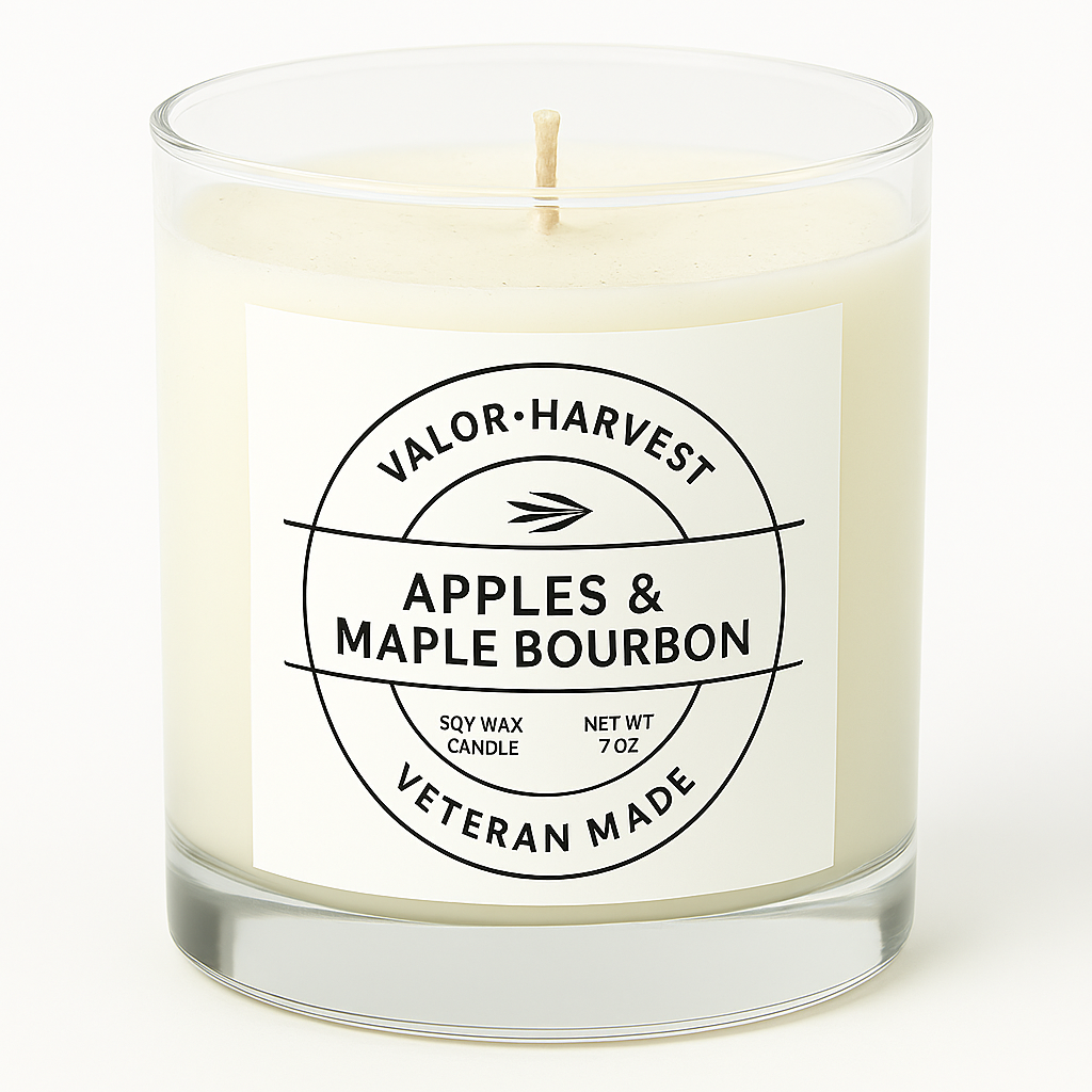 Candle with a label reading 'Apples & Maple Bourbon' by Valor Harvest on a white background