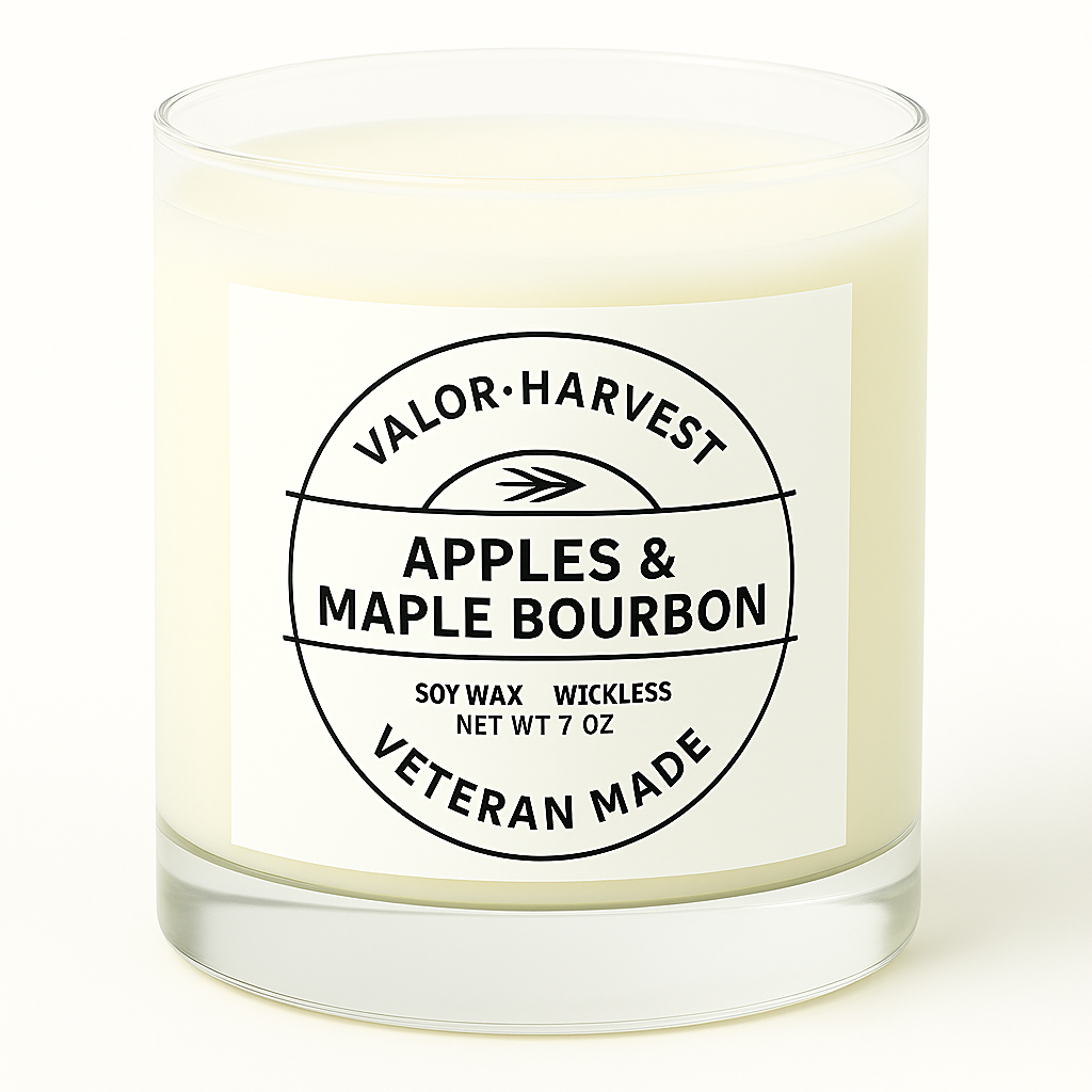 Candle with a label reading 'Apples & Maple Bourbon' by Valor Harvest on a white background
