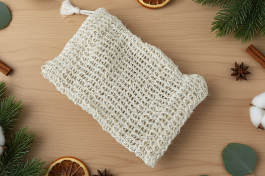 Beige loofah sponge on a marble surface.