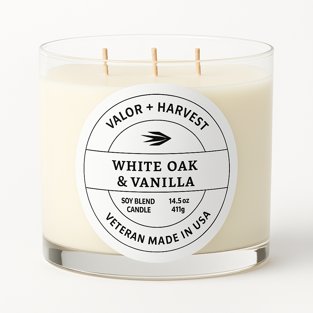 Candle with a label reading 'Valor + Harvest White Oak & Vanilla' on a neutral background