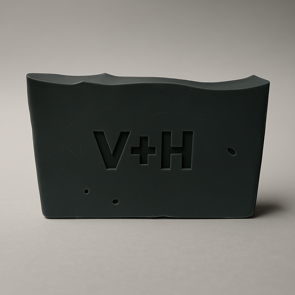 Front view of Charcoal Activated Natural Soap showing ingredients like coconut oil, shea butter, activated charcoal, and essential oils on label.
