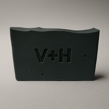 Front view of Charcoal Activated Natural Soap showing ingredients like coconut oil, shea butter, activated charcoal, and essential oils on label.