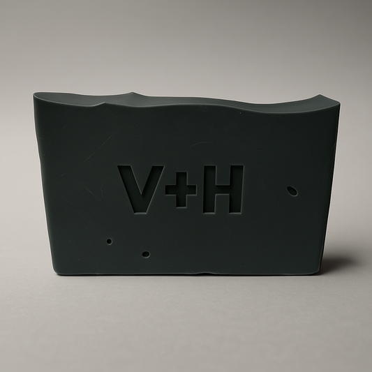 Front view of Charcoal Activated Natural Soap showing ingredients like coconut oil, shea butter, activated charcoal, and essential oils on label.