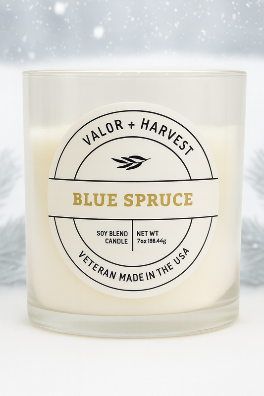 Candle with 'Valor + Harvest' label on a white background