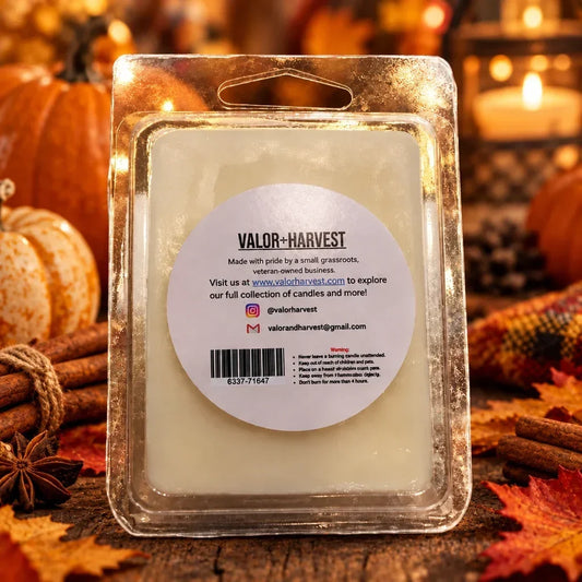Valor+Harvest Pumpkin Spice soy wax melt in clear packaging surrounded by autumn decor.