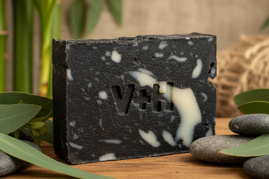 Black and white soap bar with a visible brand logo on a light background