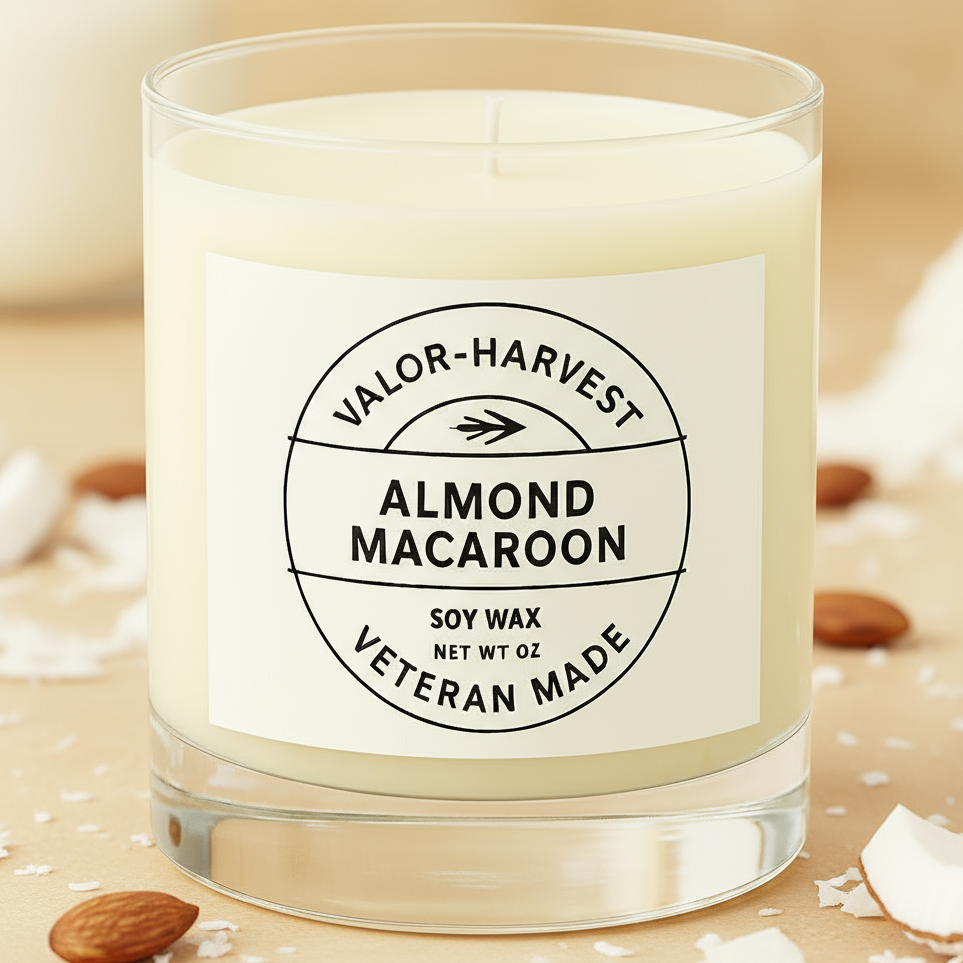 Almond macaron candle, white glass front view. 